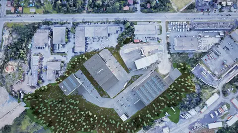 Top-down rendering of the master plan, showing three industrial buildings with parking and truck courts on a wooded site among existing industrial lots