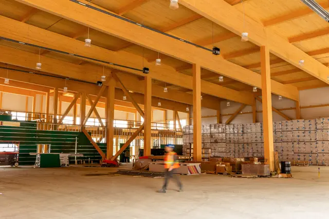 Double-height interior of the Cambrian Heights warehouse with glulam columns, beams and diagonal braces